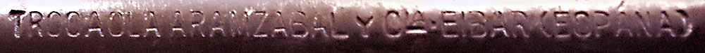 tight closeup on TAC revolver barrel stamping: TROCOLAARAMZABALyCIA EIBARESPANA